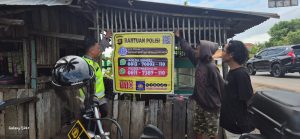 Bhabinkamtibmas Kel. Tanjung Rambang mensosialisasikan spanduk banpol di tempat keramaian